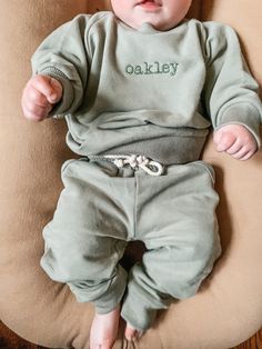 "Our embroidered sweatsuits are made with 95% organic cotton and 5% spandex. The bottoms are Jogger style pants with a functional drawstring and pockets. These run true to size. Customize this sweatshirt with your child's name Your choice of thread color and font. all names will be embroidered in a small size (around 3-4\" depending on the length of the name). Embroidery Wash and Care: -Always wash your garment before use -Your garment may have marking or clear film over the design. This will wa Kids Embroidered Sweatshirt, Organic Cotton Sweats With Ribbed Cuffs For Loungewear, Sporty Cotton Long Sleeve Set, Sporty Solid Cotton Sets, Casual Cotton Sets With Ribbed Cuffs, Cotton Tracksuit For Loungewear, Green Cotton Sweats With Elastic Waistband, Cotton Tracksuit With Ribbed Cuffs For Loungewear, Cotton Hooded Loungewear Set