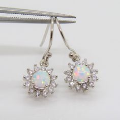 Vintage Sterling Silver White Opal & White Topaz Cluster Drop Earrings...Marked 925...Total of weights 1.8grams...Measure H 7/8'' W 3/8''...These are in very good condition. Sterling Silver Drop Earrings With Bail, Opal White, Ring Sizer, White Opal, Leaf Earrings, White Topaz, Leaf Pattern, Sterling Silber, Vintage Sterling Silver