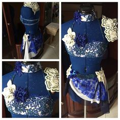 a blue dress with white flowers on the bottom and gold trimmings is shown