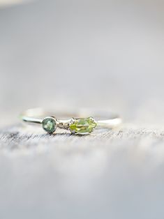 Emerald and Peridot Ring - Gardens of the Sun | Ethical Jewelry Emerald Peridot Ring, Sunlight Through Trees, Yellow Gold Moissanite Engagement Ring, Sun Jewelry, Moissanite Engagement Ring White Gold, Peridot Engagement Rings, Australian Opal Ring, Peridot Jewelry, Moissanite Engagement Ring Oval