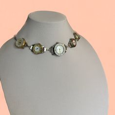 Make a statement with this stunning avant-garde necklace, featuring multiple carefully curated upcycled vintage watches. Each piece is selected for its unique charm and timeless elegance, blending vintage sophistication with a bold, cyber-futuristic edge. Inspired by travel and incorporating compass watches, this one-of-a-kind creation reflects a journey through time and space, capturing the essence of adventures and discoveries. Ideal for fans of steampunk, retro-futuristic, and cyberpunk jewelry, this necklace is a tribute to exploration and transformation. Don't miss out--grab yours now and become the center of attention! Vintage Silver Metal Jewelry And Watches, Vintage Silver Jewelry With Unique Variations, Vintage Metal Round Jewelry And Watches, Vintage Soldered Metal Jewelry, Handmade Silver Vintage Watch, Cyberpunk Jewelry, Watch Choker, Futuristic Y2k, Compass Watch