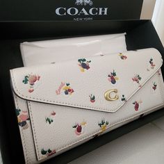 Nwt ~ Coach Wyn Soft Walletwith Paint Dab Floral Print. Authentic Genuine Polished Pebbled Leather With Brand Logo C Hardware. Snap Closure Opens To Leather Lined Interior That Features Open Bill Compartment And Eight Credit Card Slots. Back Exterior Has Zip Pocket. Designed For Casual And Formal Occasions. So Beautiful And Very Rare, Hard To Find Coach! Measurements Are 7.75" L X 3.5"H Condition Is Brand New With Tags Comes Dustbag And Original Coach Box. Ships Same Or Next Day. Luxury White Wallet Perfect For Gift, White Bifold Wallet As Gift, White Clutch Wallet As Gift, White Wallets With Removable Pouch For Everyday Use, Designer White Clutch For Everyday Use, Designer White Wallets For Formal Occasions, Elegant White Wallet As A Gift, Elegant White Wallet As Gift, Formal White Bags With Card Slots