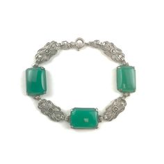 German Chrysoprase Sterling Silver bracelet from the Art Deco era. Hallmarks: The bracelet is marked Germany on the clasp and Sterling on the back of one of the Chrysoprase links. Age: circa 1920s Measurements: The bracelet weighs 12 grams and is 7 1/4 inches long. The three green gemstones measure about 5/8 inch by 1/2 inch each. Green Cabochon Bracelet For Formal Occasions, Elegant Green Cabochon Bracelets, Green Cabochon Bracelets For Formal Occasions, Formal Green Cabochon Bracelets, Formal Green Cabochon Bracelet, Elegant Green Crystal Bracelet With Natural Stones, Green Cabochon Bracelets As A Gift, Green Cabochon Bracelets For Gift, Vintage Green Bracelet With Natural Stones