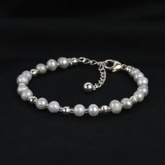 You'll love our gray pearl bracelet for its dainty design and hint of sparkle! We've paired these pearls with sterling mirror beads for a beautiful shine. This bracelet is a great quality gift! ABOUT: * Materials: sterling sliver lobster claw and sterling silver 1.5 inch extension * Beads: freshwater pearl, sterling beads * Width: 5mm SHOP OUR BRAND > https://rosaperlina.etsy.com WHAT IS STERLING SILVER? * Sterling silver is a mix of 92.5% of silver and 7.5% of other metals, typically copper. * Silver Pearl Chain Bracelet For Everyday, Elegant Gray Bracelets As Gift, Everyday Silver Pearl Chain Bracelet, Elegant Gray Bracelets For Gift, Elegant Gray Bracelet As Gift, Elegant Gray Bracelet For Gift, Elegant Adjustable Gray Jewelry, Elegant Gray Beaded Bracelets With Silver Beads, Everyday Silver Bracelets With Pearl Chain