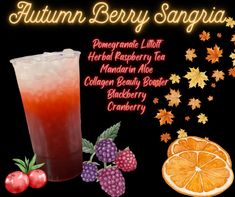 an orange and raspberry iced drink next to some fruit on a black background with the words autumn berry sangria