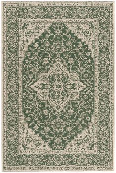 a green and beige rug with an ornate design