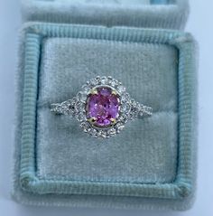 Beautiful pink sapphire diamond ring set in 18K White Gold. Excellent craftsmanship on this ring. The diamonds are all white and super sparkling. The split shank band is a pretty design detail. This pink sapphire is a beautiful light pink color. This ring is not flashy, but elegant and classy. Pink sapphires are hard durable stone and it sparkles a lot! The white gold feels nice and solid. The halo measures 11.1 x 10mm. Genuine pink sapphire oval cut 6.2 x 5 mm 0.9 Carats Beautiful pink color an Gia Certified Pink Sapphire Rings For Formal Occasions, Fine Jewelry Gia Certified Pink Sapphire Diamond Ring, Gia Certified Fine Jewelry Pink Sapphire Diamond Ring, Gia Certified Pink Sapphire Diamond Ring, Gia Certified Pink Sapphire Diamond Ring In Fine Jewelry, Formal Pink Diamond Ring In Platinum, Gia Certified White Gold Pink Sapphire Jewelry, Luxury Gia Certified Pink Sapphire Diamond Ring, Gia Certified Pink Platinum Rings