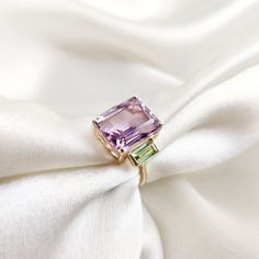 This stunning ring is set in 14k Solid Yellow Gold with Natural Pink Amethyst and Peridot with utmost precision. It is an unique statement gemstone ring for nearly every occasion and is completely hassle-free jewelry. ITEM DETAILS * Center Gem: Pink Amethyst  * Gem Size: 10x12mm * Gem Shape: Octagon * Side Gem: Peridot * Gem Size: 3x6mm * Gem Shape: Baguette * Gem Weight: 7.21 carats * Gold Purity: 14KT * Gold Weight: 2.10 gram * Total Weight of the Ring: 3.54 gram The Gold purity is guaranteed and it comes with authentic 14KT gold hallmark. Since my items are handmade, they are absolutely nickel and lead free. CUSTOMIZATION: * Size Customization is available for this ring and it is available in all ring sizes. Kindly choose your ideal ring size from the drop-down. * Gemstone customization Amethyst And Peridot Ring, Green Amethyst Ring In 14k Gold, Green Amethyst Rings In Fine Jewelry Style, Fine Jewelry Amethyst Ring For May Birthstone, Pink Gem Ring, Amethyst And Peridot, Handmade Jewelry Box, Peridot Jewelry, Pink Gem