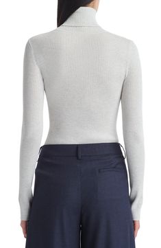 Soft ribbing lends a close fit to this layer-perfect turtleneck sweater knit from pure merino wool. 23" length Turtleneck Long sleeves 100% merino wool Dry clean Made in the USA Fitted Ribbed Merino Wool Sweater, High Neck Cashmere Tops For Work, Ribbed Cashmere Turtleneck Top, Elegant Fitted Knit Top With Ribbed Collar, Workwear Ribbed Merino Wool Tops, Ribbed Merino Wool Tops For Work, Merino Wool Ribbed Sweater For Work, Merino Wool Ribbed Tops For Work, Fitted Wool Tops For Business Casual