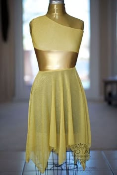 a mannequin with a yellow dress on display