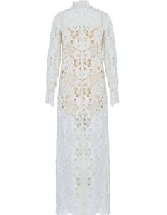 a white lace dress with long sleeves and an openwork design on the front,