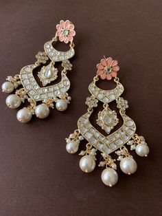 Beautiful Gold Kundan ChandBali Earrings with floral motif  embellished in three different colours. Ready to make a style statement this wedding season? Three colours available - Peach, baby pink and pastel grey/white Festive Pearl Drop Bridal Earrings For Reception, Festive Bridal Earrings With Pearl Drop For Reception, Festive Bridal Pearl Drop Earrings For Reception, White Stone Work Chandelier Earrings For Wedding, White Chandelier Earrings With Stone Work For Wedding, White Chandelier Earrings For Wedding, Bollywood Meenakari Pearl Earrings For Reception, White Chandelier Earrings For Wedding And Festive Occasions, Festive White Chandelier Earrings For Weddings