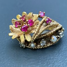 We take pride in finding unique , quality ~ Antique /Vintage jewelry pieces which are carefully hand picked by us so that you can add them to your treasure/ collection or gift to someone you love ~ We try to add plenty of items every week and have been selling online for more then 10 years . Vintage ~ 14kt yellow gold ~ Diamond ~ rubies ~ seed pearl ~ Cocktail /dinner ring ~ There are 6 small prong set faceted rubies , 3 diamonds and two seed pearls with applied wire work ~ Very well made ring . Vintage Pearl Ring With Gemstone, Heirloom Multi-stone Pearl Ring Gift, Heirloom Multi-stone Pearl Ring As Gift, Vintage Multi-stone Ruby Ring In 14k Gold, Vintage Gold Hallmarked Pearl Ring, Vintage One-of-a-kind Wedding Rings, Vintage Yellow Gold Pearl Ring With Gemstone, Vintage Multi-stone Pearl Ring For Anniversary, Vintage 14k Gold Pearl Ring