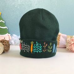 "The embroidered beanie hat is handmade one stitch at a time on the hat. It is embroidered only on the front. 🧶 Measurement: approximate 7\"-8\" in length. 🧶 Washable alone with the laundry bag, gentle or dedicated cycle. 🧶 DO NOT DRY by DRYER; HANG DRY ONLY! 🌸 Thanks for visiting my little shop, located in Pittsburgh, PA! Please do not hesitate to contact me if I could further assist/information on this item." Embroidered Winter Hats, One Size Cotton Cap, Green Cotton Hat One Size, Embroidered Cotton Beanie, One Size Fits Most, Embroidered Cotton Beanie One Size Fits Most, Embroidered Cotton Beanie (one Size Fits Most), Embroidered Cotton Beanie One Size, Handmade Cotton Winter Hats, Embroidered Cotton Beanie