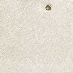 a white leather texture with a gold ring on the center and bottom part of it