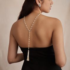 The Carina necklace is the perfect piece for adding glamour to the front and back of your bridal gown. Made to be versatile, this Czech glass pearl necklace can be worn with the crystal-encrusted tassel facing front or at the back, leaving an elegant strand of pearls around the front of the neck and accentuating any open-back gown. All jewelry is made to order in our New York City design studio. Please allow 7-14 business days for production from the order date. Measurements: 30.75" L Open Back Gown, Strand Of Pearls, City Design, Bridal Necklace, Bridal Gown, Elevate Your Look, Czech Glass, Clothes Accessories, Bridal Gowns