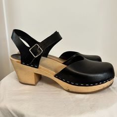 Swedish Hasbeens Leather Slingback Pumps, Black, Round-Toes, Block Heels With Platform, Straps & Buckle Closure At Ankles, 3" Heel. Materials: Leather And Wood Size: Eur 41/Us 10 Condition: Used - See Pictures For Details, Happy To Answer Any Questions! Chic Clogs With Ankle Strap And Buckle Closure, Chic Ankle Strap Clogs With Buckle Closure, Chic Clogs With Wooden Heel And Ankle Strap, Classic Black Slingback Mules, Chic Ankle Strap Clogs With Wooden Heel, Classic Black Slingback Sandals With Buckle, Black Slingback Mules With Removable Insole, Classic Black Slingback Sandals With Buckle Closure, Black Slingback Sandals With Buckle Closure