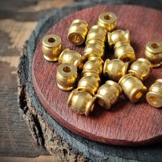 several brass screws sitting on top of a wooden board