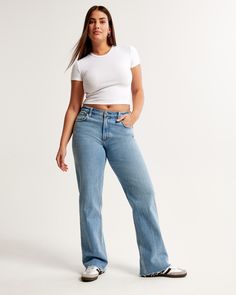 Our Curve Love low rise baggy jeans in a medium wash with a raw hem. This fit features a 8.5” low rise, is slightly relaxed at waist and hips, and eases at the thigh into a baggy, full-length leg shape. We recommend buying your true size for a baggier fit. Size down for a closer fit. Our Curve Love styles add an additional 2” at the hip and thigh to allow room for your curves and eliminate waist gap. This jean is made from our vintage stretch fabric which features both an authentic vintage look Jean Collection, Jean Fits, Female Features, Low Rise Baggy Jeans, Baggy Jean, Women's Bottoms, Comfortable Jeans, 2024 Christmas, Birthday List