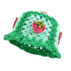 a green crocheted hat with a strawberry on it