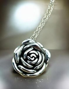 Elevate your jewelry collection with our exquisite Rose Flower Pendant Necklace, masterfully crafted from premium 925 Sterling Silver. This hollow-formed pendant showcases an intricate rose design, offering an elegant and timeless aesthetic. The pendant dimensions are a tasteful 1 inch by 1 inch, perfect for making a subtle yet impactful statement. For a harmonious look, you have the option to pair the pendant with a matching 18-inch cable link necklace, also fashioned from high-quality 925 Ster Silver Rose Design Jewelry For Formal Occasions, Elegant Silver Necklace With Rose Design, Rose Sterling Silver Necklace For Anniversary, Rose Sterling Silver Jewelry For Mother's Day, Rose-colored Sterling Silver Necklace For Anniversary, Rose-colored Sterling Silver Jewelry For Mother's Day, Silver Rose Design Necklace For Anniversary, Mother's Day Rose-colored Sterling Silver Jewelry, Silver Rose Detail Sterling Silver Jewelry