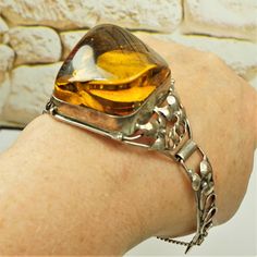 IRREGULAR AMBER Silver BRACELET, Openwork Floral Design Bangle 6.5", Super Huge Baltic Amber Optic Transparent Stone, Rare Gift For Women by ANTIQUE4YOU Super Huge Baltic Amber Optic Transparent Stone! Beautiful genuine Baltic amber 3D optic HUGE HONEY amber TRANSPARENT stone filled with inclusions and old sterling silver composition. AMAZING UNIQUE VERY HIGH RAW AMBER CABOCHON! UNIQUE FLORAL DESIGN BANGLE. SECURED CLOSURE. In perfect conditions. Size of stone 1 3/4" x 1 1/2" x 1". INSIDE BRACEL Unique Floral Design, Rare Gifts, Amber Bracelet, Baltic Amber, Bracelet Sizes, Gift For Women, Estate Jewelry, Small Gifts, Beautiful Jewelry