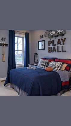 a bedroom with gray walls and blue bedding has pictures on the wall above it