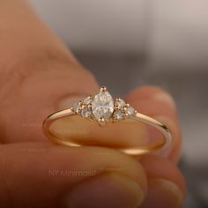 a person holding a diamond ring in their hand