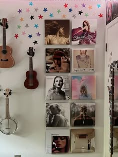 there is a wall with many pictures on it and a guitar hanging from the wall