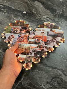 a hand is holding up several photos with lights on them and some are placed in the shape of a heart