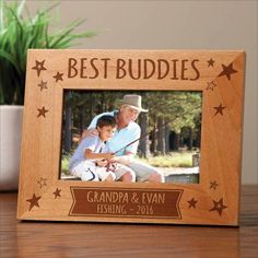 a wooden frame with the words, best buddies and an image of a boy holding a fishing rod