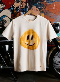 Cheap Playful Shirt With Graphic Print, Playful Cheap Shirt With Graphic Print, Cheap Unisex Playful T-shirt, Cheap Playful Graphic Print Shirt, Fun Cotton T-shirt, Affordable Embroidered Graphic Tee, Playful Cheap T-shirt, Affordable Playful Short Sleeve T-shirt, Casual Smiley Face T-shirt