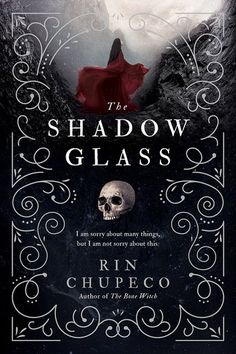 the shadow glass book cover with a skull in the middle and a red cloak over it