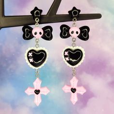 "Pastel goth earrings- fun cute cartoon earrings - skull bow cross heart - statement earrings - Japanese street fashion earrings Fun kawaii earrings perfect for the pastel goth lover! Stay stylish in these black and pink goth style earrings. 12mm wide plastic and silicone rubber backings included for comfort **Stainless steel earring posts are hypoallergenic and nickel free Made of resin / plastic Charms are one sided and flat on the back Earring length is: 3 5/8\" (in) Earring width is: 1\" (in Pink Goth Jewelry, Cute Goth Earrings, Kawaii Goth Accessories, Black Emo Earrings For Gift, Harajuku Style Black Jewelry, Emo Halloween Pierced Earrings, Halloween Emo Pierced Earrings, Harajuku Style Halloween Jewelry Gift, Black Harajuku Style Jewelry Gift