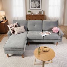 a living room with a gray couch and coffee table in front of a large window