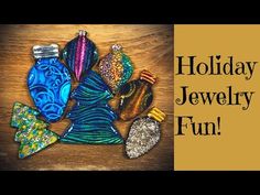 a wooden table topped with lots of different colored glass ornaments and words that read holiday jewelry fun