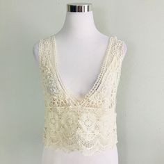 Sleeveless Sheer Lace Top Features A Plunging Neckline And Scalloped Hem. (Under Tank Not Included) Fabric Content: 100% Cotton Size Scale: One Size Description: L: 18" B: 30" W: 34". Firm Price Elegant Fitted V-neck Crochet Top, Crochet Lace V-neck Crop Top For Summer, Summer V-neck Crop Top With Lace Trim, Fitted V-neck Crochet Top For Summer, Chic Cream V-neck Crochet Top, Elegant Beige V-neck Crochet Top, Fitted Sleeveless Tank Top With Delicate Lace, Summer V-neck Tops With Crochet Lace, Sleeveless Lace Crop Top With Lace Trim