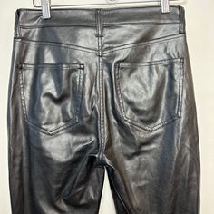 The Gap "Vintage" Slim High Rise Black Faux Leather Pants offer a classic and stylish look. These leather pants are constructed from a high-quality faux leather with a slim fit and a high rise for a timeless silhouette. High waisted fit with a straight leg. These are not vintage; however, they are a recreation of a retro style. Women's size 6 Measurements with the garment laying flat: Waist: about 15 inches Rise: about 11 inches Inseam: about 26 inches Hips: about 18 inches High Rise Leather Pants For Fall, High Rise Leather Jeans For Fall, Mid-rise Leather Pants For Night Out, Gap High Rise Pants For Fall, Straight Leg Faux Leather Jeans For Work, Faux Leather Straight Leg Jeans For Work, Fitted Faux Leather Classic Bottoms, Classic Fitted Faux Leather Bottoms, High Waist Faux Leather Jeans For Night Out