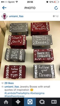 several small cakes with writing on them sitting on top of a white table next to a computer mouse