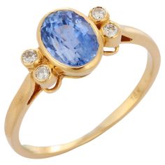 Blue Sapphire ring in 18K Gold which perfectly goes with your personality and also helps you to learning and spiritual healing. Designed with Blue Sapphire in center and diamonds at sides that makes it a perfect fit to wear it on your wedding or style it with any of your basic outfit to give it a glam. PRODUCT DETAILS :- > Material - 18K Solid Yellow Gold > Gemstone - Blue Sapphire > Gemstone Weight - 2.08 ct > Stone Shape - Oval > Stone Size - 8.5 mm > Diamond Weight - 0.11 ct > Diamond pcs - 4 Luxury Yellow Gold Rings With Lab-created Sapphire, Sapphire Diamond Wedding Ring, Sapphire And Diamond Band, Contemporary Engagement Rings, Gold Solitaire Ring, White Gold Sapphire, Blue Sapphire Ring, Wedding Rings Halo, Gold Gemstone Ring