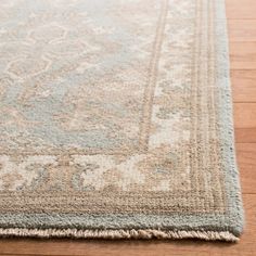 a light blue and beige rug on the floor