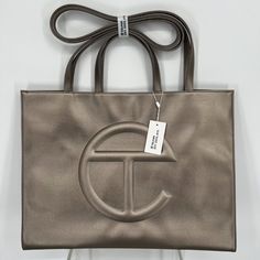 Brand New With Tags And Dustbag Telfar Large Shopper Tote Bag Handbag Vegan Leather Crossbody Bronze W/ Dustbag Tan Shopping Bags With Double Handle, Top Handle Tan Bag For Shopping, Tan Bags With Dust Bag For On-the-go, Tan Top Handle Shopping Bag, Tan Top Handle Bag For Shopping, Tan Double Handle Shoulder Bag For Shopping, Tan Bags With Detachable Handle, Tan Bags With Detachable Handle For Shopping, Tan Bag With Detachable Handle