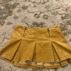 Color: Yellow. Corduroy Material. New With Tags. Size Medium. Yellow Corduroy Skirt Outfit, Yellow Mini Skirt With Pockets, Trendy Yellow Mini Skirt For Fall, Yellow Mini Skirt For Fall, Yellow Cotton Pleated Mini Skirt, Spring Pleated Bottoms From Urban Outfitters, Trendy Yellow Lined Skort, Casual Mustard Skirt, Yellow Cotton Skort