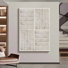 a living room with a couch and chair next to a book shelf on the wall