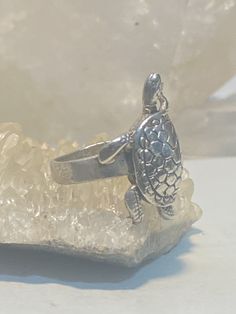 "Turtle ring tortoise pinky band sterling silver women girls Size 4.75 Between a size 4.75 and a size 5 Weight 6.1g Length. 1 1/8 Width 5/8\" Thinnest part of band 7/32\" Free Shipping and Postal Insurance Delivered in a Gift Box If you do not want the ring polished and want to leave the natural patina please let me know at the time of purchase as I do polish rings before I ship rings out. Thanks Free First Class shipping and postal insurance is included. If you want to upgrade to priority kindl Silver Turtle Jewelry, Sterling Silver Turtle-shaped Rings, Turtle Ring, Poison Ring, Spoon Rings, Sterling Silver Bands, Silver Band, Stone Rings, Tortoise