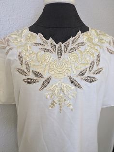 beautiful lightweight blouse assuming cotton beautiful embroidered and Cutwork detail handmade cream with tan and beige soft neutral colorway Dolman sleeve silhouette  p2p up to 23.75" waist 20. 5" across one side  length 28" one tiny spot on inside of neck , very faint see pic no tags but looks like Hungarian embroidery Elegant Beige Floral Embroidered Top, Spring Embroidered Gold Top, Embroidered Gold Top For Spring, Gold Embroidered Top For Spring, Cream Short Sleeve Tops With Floral Embroidery, White Cotton Blouse With Tonal Embroidery, Cream Cotton Blouse With Floral Embroidery, Cream Embroidered Short Sleeve Blouse, Cream Summer Tops With Chikankari Embroidery