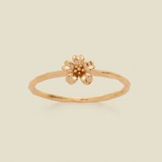 a gold flower ring on a white background