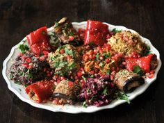 a white plate topped with lots of food on top of a wooden table