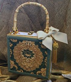 a small purse with a bow on the handle