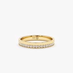 a yellow gold band with white diamonds